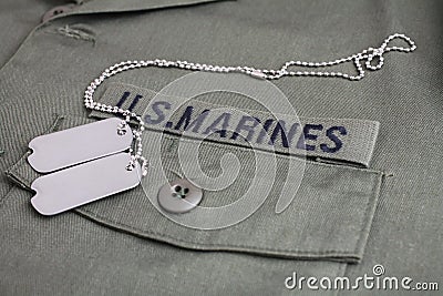 U.S. MARINES Branch Tape with dog tags on olive drab uniform Stock Photo