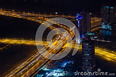 UAE, Dubai, 06/14/2015, downtown dubai futuristic city neon lights and sheik zayed road shot from the worlds tallest tower Editorial Stock Photo