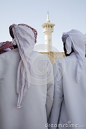 UAE Dubai group of traditionally dressed Muslim men perform a song for visitors to the Bastakia Stock Photo