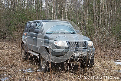 UAZ-Patriot stuck in the mud, in woods, april Editorial Stock Photo