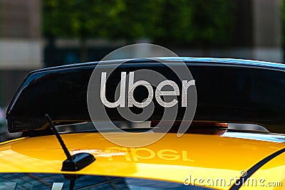 Uber logo icon on top of yellow taxi cab, close up Editorial Stock Photo