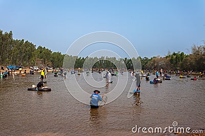 Ubon Ratchathani, Thailand - March 20, 2020 : Many Thai people casting a net for catching fish at river. Fishermen show ancient Editorial Stock Photo