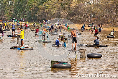 Ubon Ratchathani, Thailand - March 20, 2020 : Many Thai people casting a net for catching fish at river. Fishermen show ancient Editorial Stock Photo