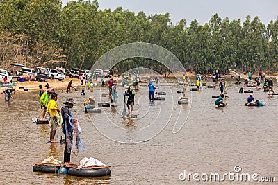 Ubon Ratchathani, Thailand - March 20, 2020 : Many Thai people casting a net for catching fish at river. Fishermen show ancient Editorial Stock Photo