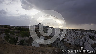 Uchisar Castle view from white valley in Cappadoccia with storm clouds, Turkey Stock Photo