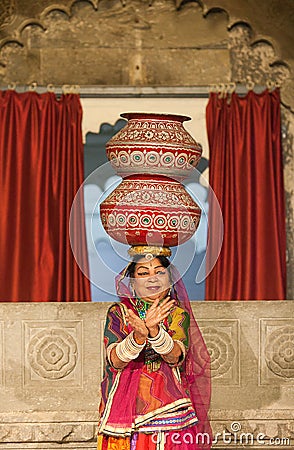 Indian woman in sari performs Rajasthani folk dance with pots on the head Editorial Stock Photo