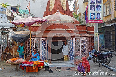 A family in front of a small store of the traditional market in Udaipur Editorial Stock Photo