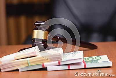 udge`s gavel and bundles of money on the judge`s table Corrupt court Stock Photo