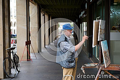 Udine. Italy. August 2023. Authentic side portrait of an elderly male artist, painter drawing on canvas outdoors Editorial Stock Photo