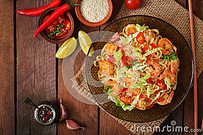 Udon pasta with shrimp, tomatoes and paprika. Stock Photo