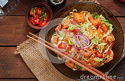 Udon pasta with shrimp, tomatoes and paprika. Stock Photo
