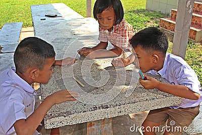 Three Asian children are playing together in lunch-break. Editorial Stock Photo
