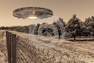 UFO, an alien plate hovering over the field, hovering motionless in the air. Unidentified flying object, alien invasion, Stock Photo