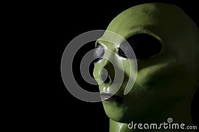 UFO and extraterrestrial life encounter of third degree concept theme with close up on the face of a green alien with high Stock Photo