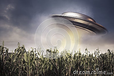 UFO hovering over a crop field Stock Photo