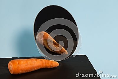 Ugly carrots. Reflection in the mirror. Concept-low self-esteem. Copy space Stock Photo