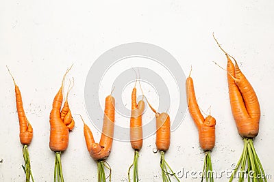 Ugly carrots on a white background. Ugly food concept, top view Stock Photo