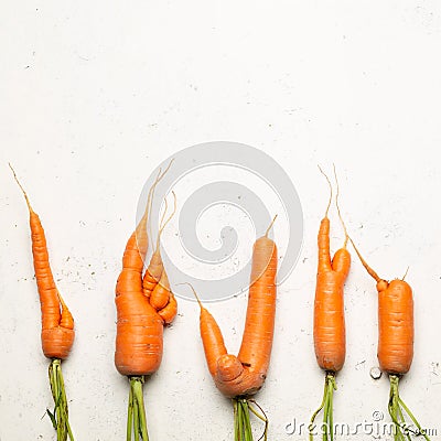 Ugly carrots on a white background. Ugly food concept, top view Stock Photo