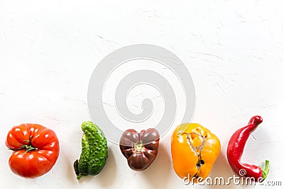 Ugly organic colorful tomato, pepper, cucumber on white concrete table Stock Photo