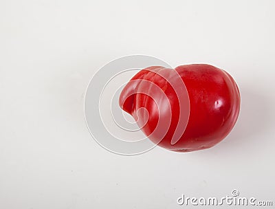 Ugly tomato on a white background. Horizontally. Ugly vegetables. Deformed vegetables. Copy spaes Stock Photo