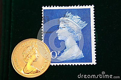 UK blue stamp with portrait of Elizabeth II and 1980 Australian Gold sovereign on black background Editorial Stock Photo