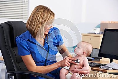 UK doctor examining baby Stock Photo