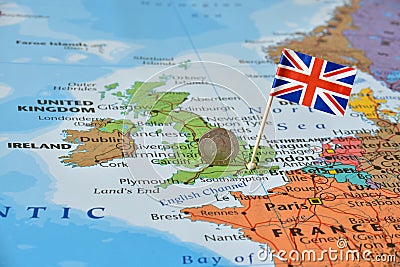 UK flag and coin on map, political or financial crisis concept Stock Photo