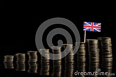 UK flag with lot of coins on black Stock Photo