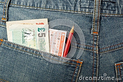 UK money and lottery bet slip in pocket Editorial Stock Photo