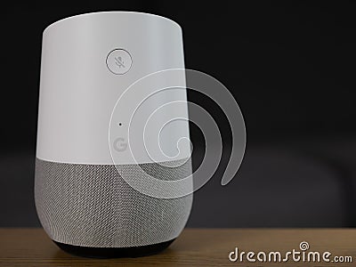 UK, October 2019: Google Home smart speaker on wooden table in lounge Editorial Stock Photo