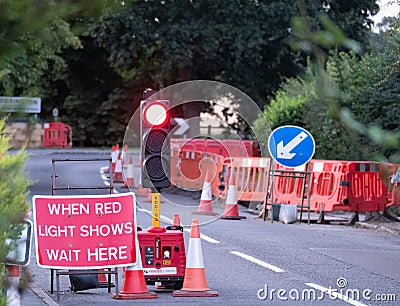 Uk roadworks on village road with red stoplight traffic control Editorial Stock Photo