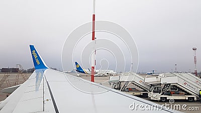 Ukraine, Borispol - March 27, 2020: view from the window of the seat of a commercial passenger plane on a wing parked at the Editorial Stock Photo