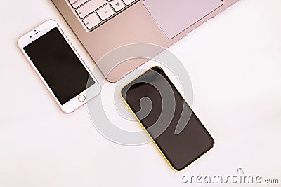 20.08.2019 Ukraine: Closeup yellow iphone xr and pink iphone 6s on isolated background with part of computer Editorial Stock Photo