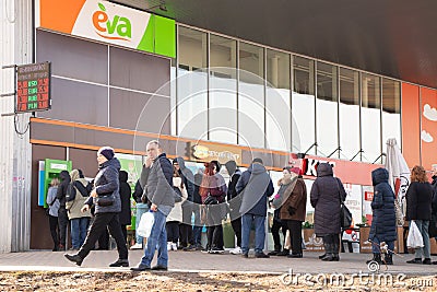 Ukraine Dnepr 24.02.2022 - People queuing for pharmacy stores and ATMs stand on the streets of the city on the first day Editorial Stock Photo