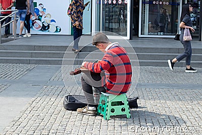 Ukraine Dnepr 10.07.2021 - A street musician plays a guitar on the street in the city center in summer Editorial Stock Photo