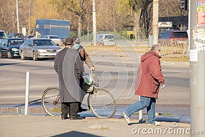Ukraine, Dnipro - April 07, 2020. People of the city of Dnieper during the quarantine in the morning on the street, failure to Editorial Stock Photo