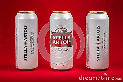 Ukraine. Dnipro. 20 march 2023: Three white can of great Belgium beer Stella Artois on red background Editorial Stock Photo