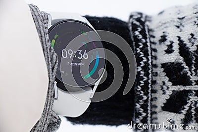 Ukraine Dnipro 26.12.2021 - Smart watch Samsung Galaxy 4.40 mm on a girl`s hand in winter on the street, technology Editorial Stock Photo