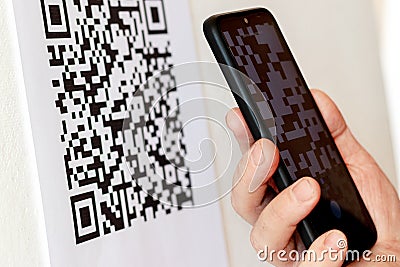 Ukraine, Khmelnitsky, April 20120. A man with a phone in his hand scans the qr code when shopping for goods Stock Photo