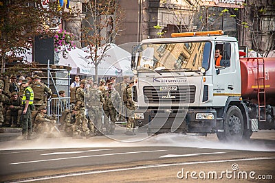 Ukraine, Kiev, August 24, 2018. Watering machine white and orange color washes the streets of Kyiv Editorial Stock Photo