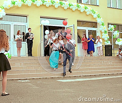 Ukraine Kiev May 2019. Graduation class go to the line in the open school yard, at the last bell festival for parents Editorial Stock Photo