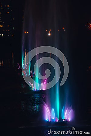 Ukraine. Kyiv - 05.06.2019 Amazing dancing fountain in the night illumination of rainbow color with colorful illuminations on the Editorial Stock Photo