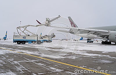 Ukraine, Kyiv - February 12, 2021: De-icing the aircraft before the flight. The deicing machine. Passenger plane with antifreeze. Editorial Stock Photo