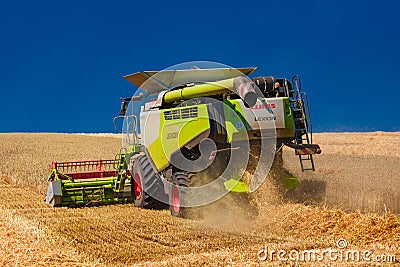 Ukraine. Kyiv. JULY 23, 2022: Modern combine Claas Lexion harvesting grain in the field.Combine harvest on grain field. Editorial Stock Photo