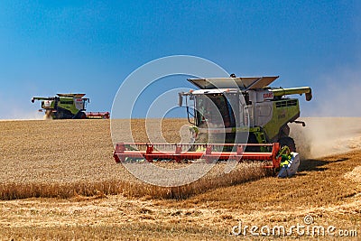 Ukraine. Kyiv. JULY 23, 2022: Modern combine Claas Lexion harvesting grain in the field.Combine harvest on grain field. Editorial Stock Photo