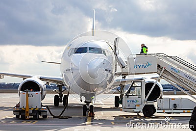 Ukraine, Kyiv - March 19, 2021: Plane at the airport on the apron. Boeing 737-800 UR-UBA Passenger aircraft. Refueling Editorial Stock Photo