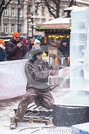 Ukraine, Lviv - January 11, 2019: Master makes ice sculptures from ice. Ice Sculpture Festival Editorial Stock Photo