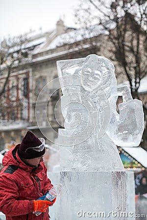 Ukraine, Lviv - January 11, 2019: Master makes ice sculptures from ice. Ice Sculpture Festival Editorial Stock Photo