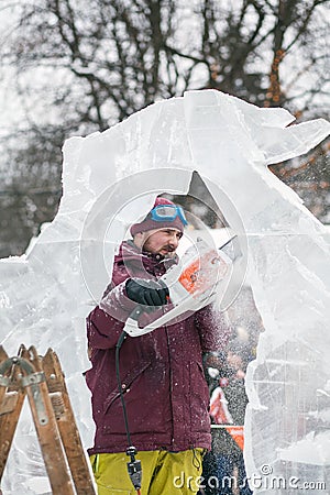 Ukraine, Lviv - January 11, 2019: Master makes ice sculptures from ice. Ice Sculpture Festival Editorial Stock Photo