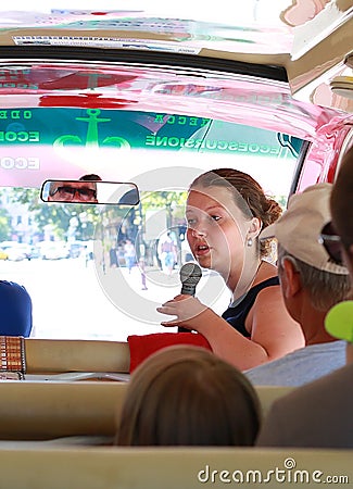 Ukraine Odessa July 2018. A guide on a tourist bus conducts an interesting tour, tourists listen very carefully. Tourism concept. Editorial Stock Photo